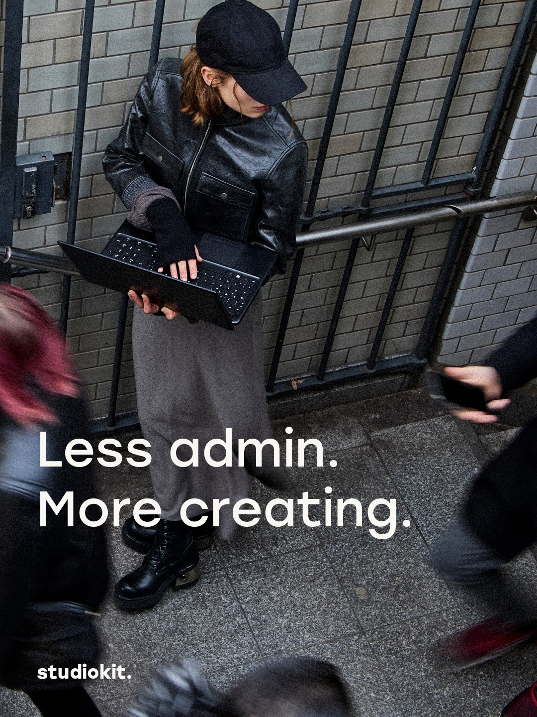 studiokit. campaign: a person using a laptop on a stairway. Less admin. More creating.